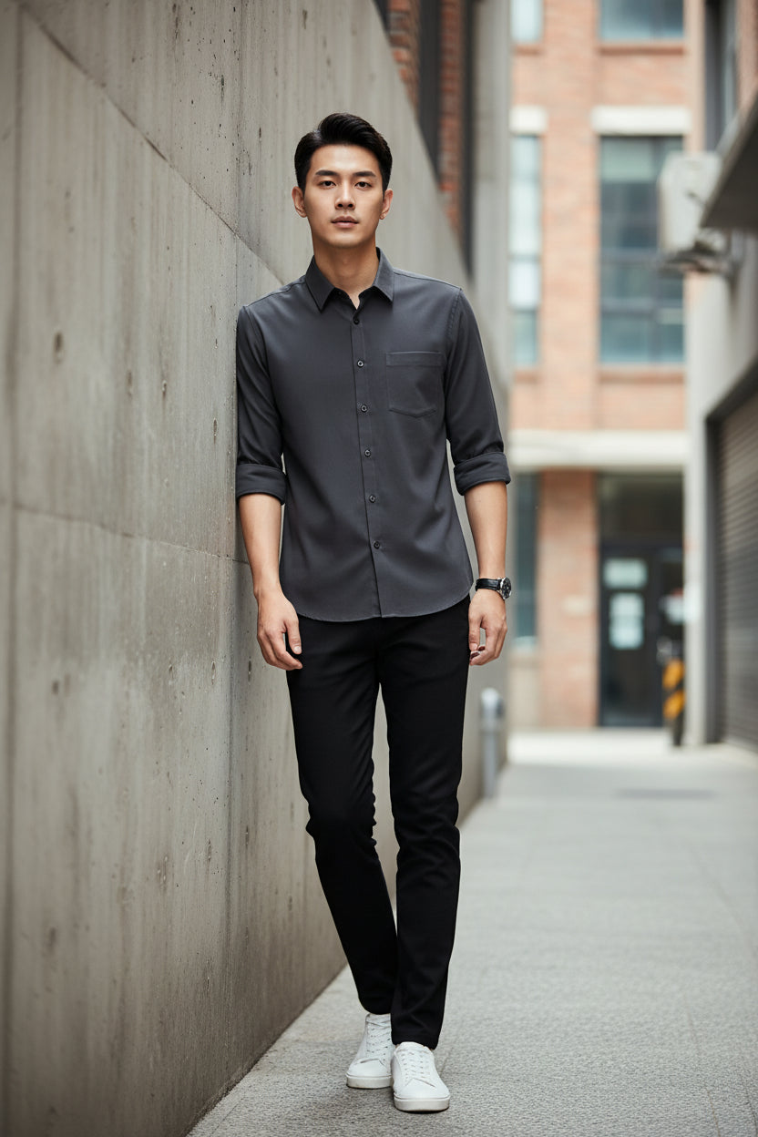 Dark gray shirt on a hanger against a white background
