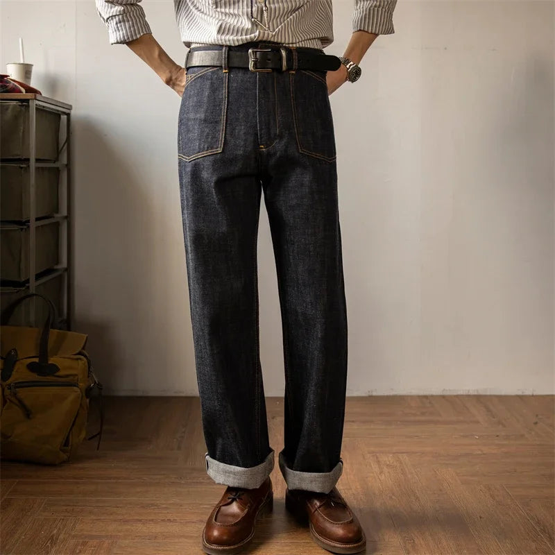 Person wearing dark jeans and brown shoes in a room with a wooden floor and a shelf.