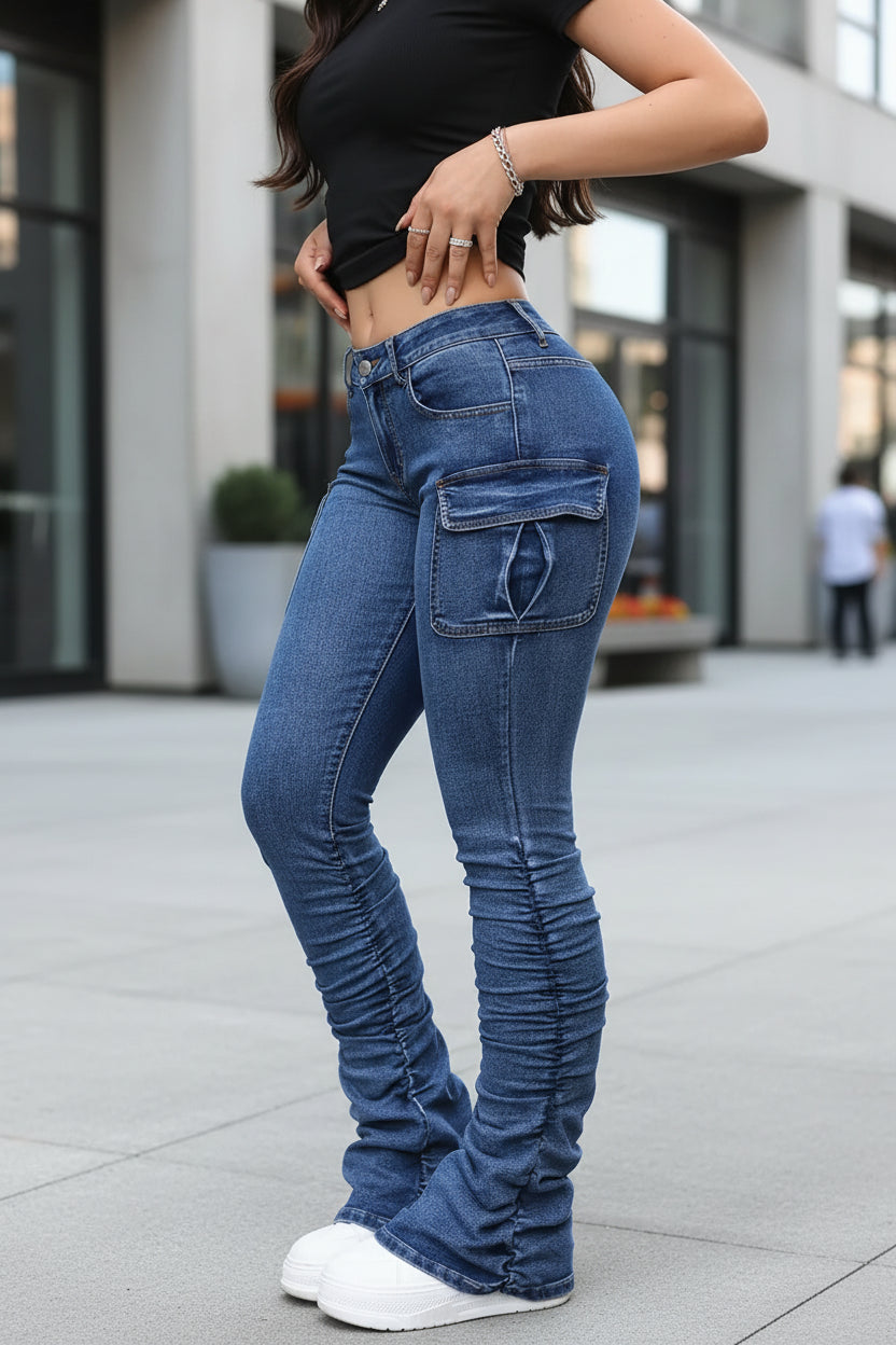 Person wearing blue jeans with a neutral background