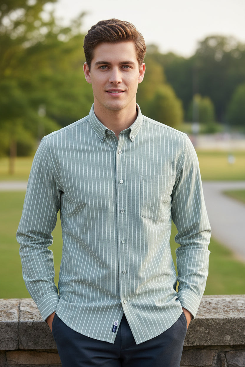Folded light blue and white striped shirt with a brand label on a light gray background