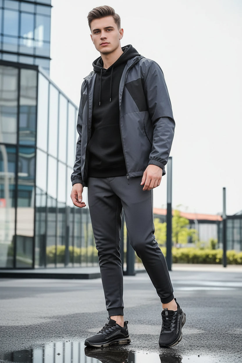 Black running shoes with a reflective sole on a reflective surface.