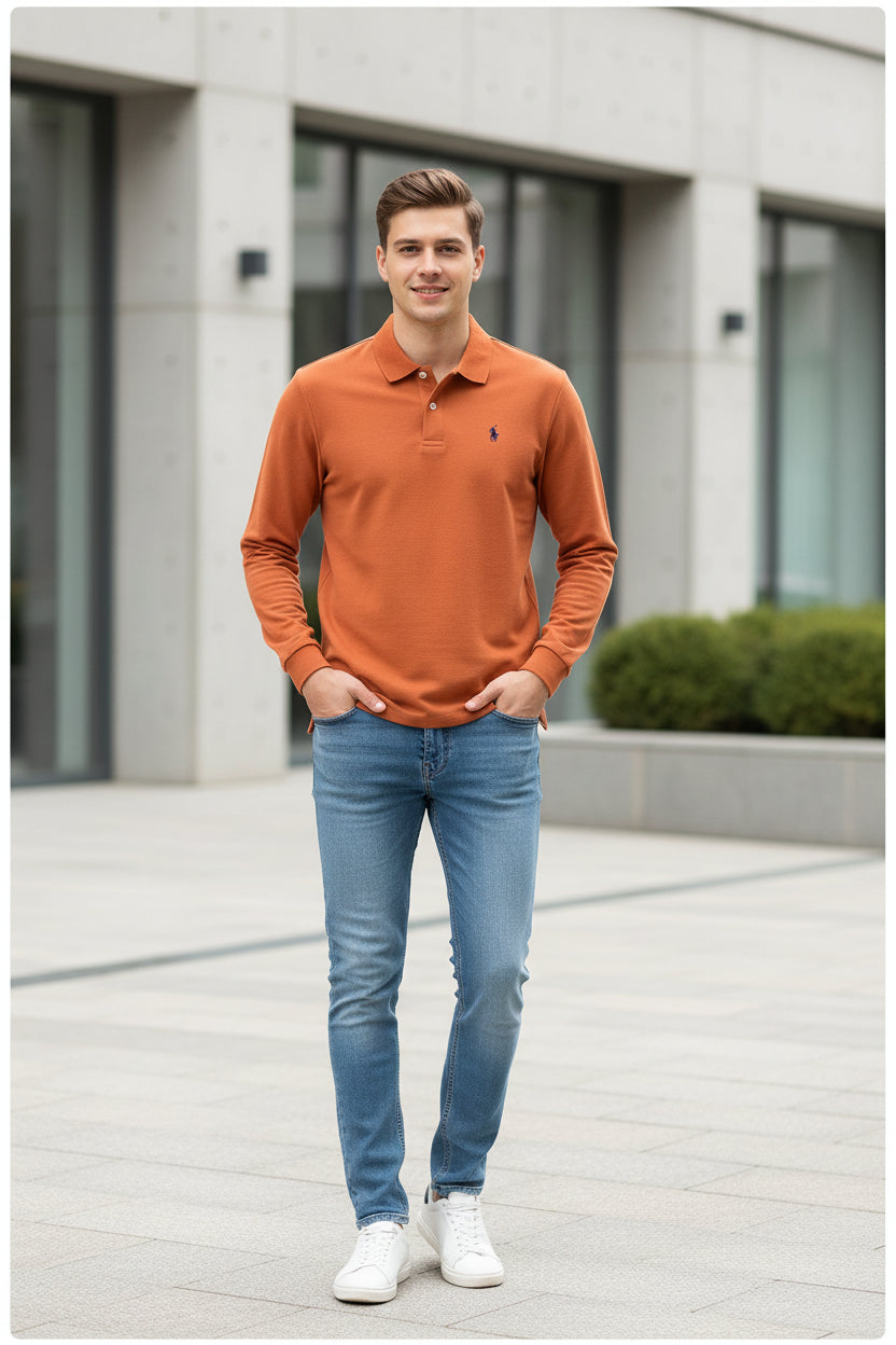 Orange polo shirt with a brand logo on a hanger against a background of other shirts.