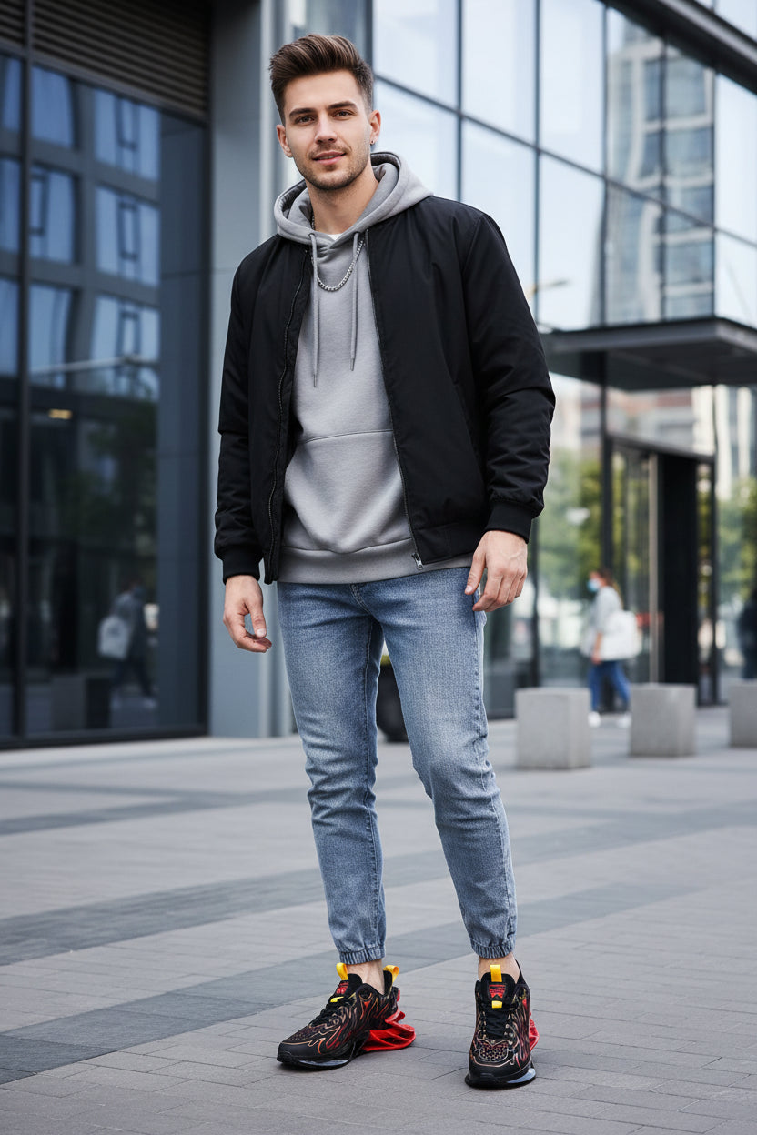 Black and red athletic shoes with flame design worn by a person on a blurred street background