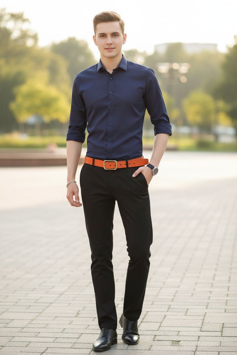 Navy blue shirt worn by a person with an orange belt on a gray background