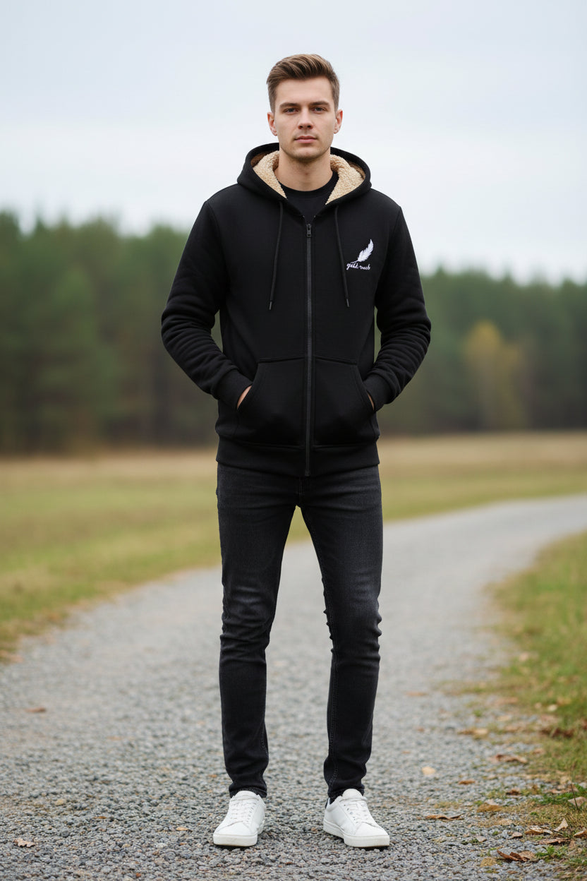 Black hoodie with beige lining on a textured beige background