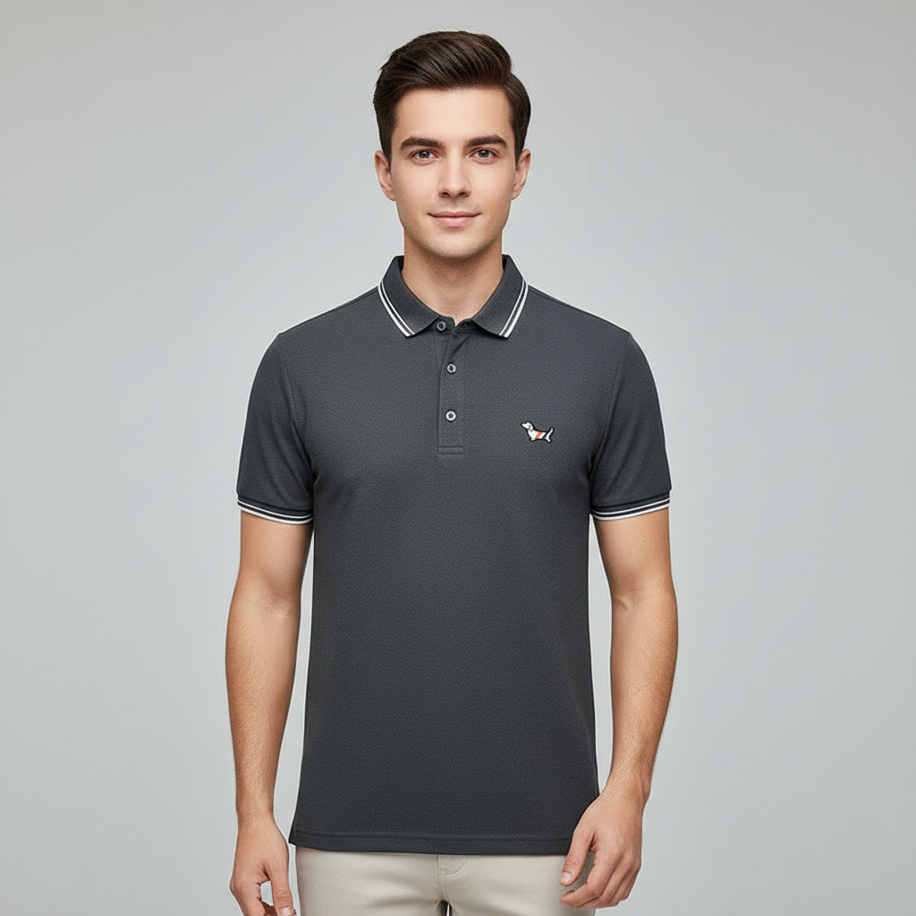 Dark gray polo shirt with brand logo on a rack with other shirts in the background