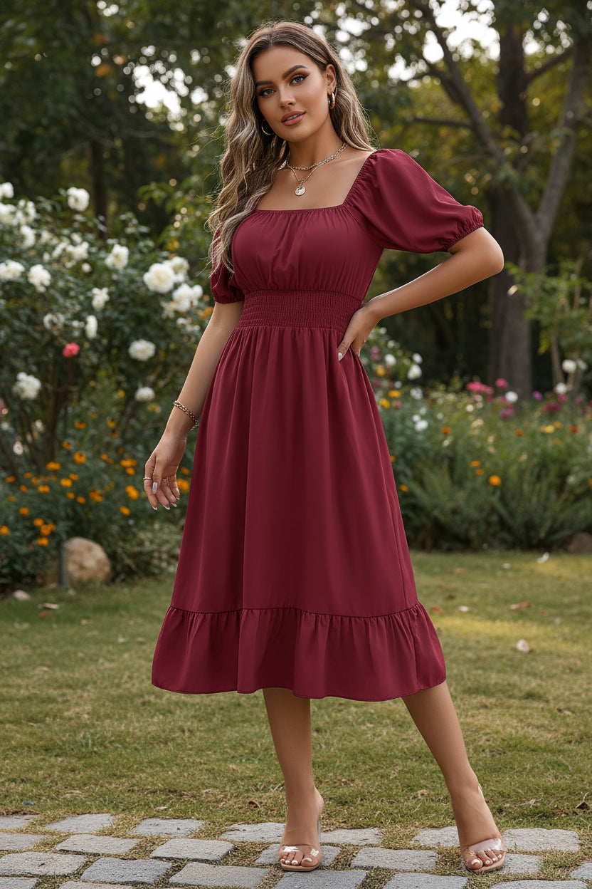 Woman wearing a burgundy dress with puff sleeves in a casual setting.