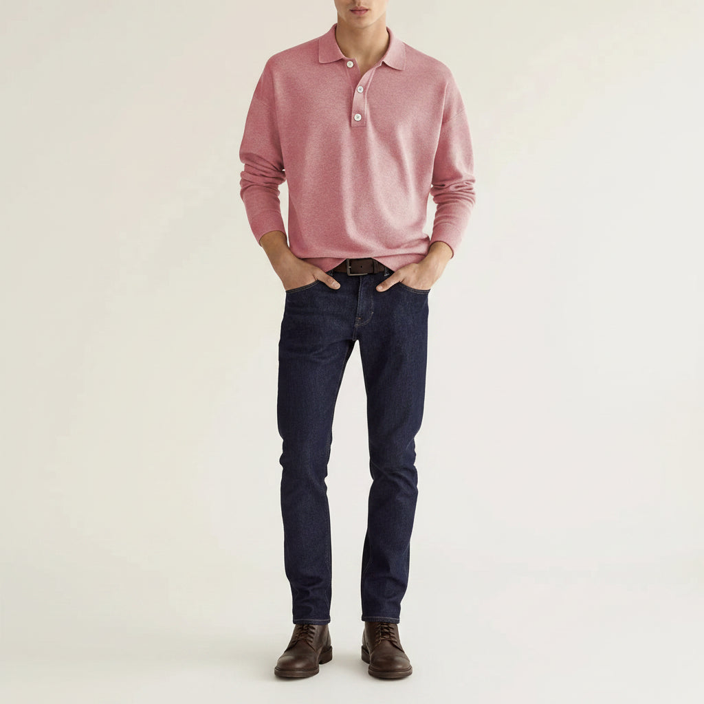 Person wearing a pink long-sleeve polo shirt against a beige background