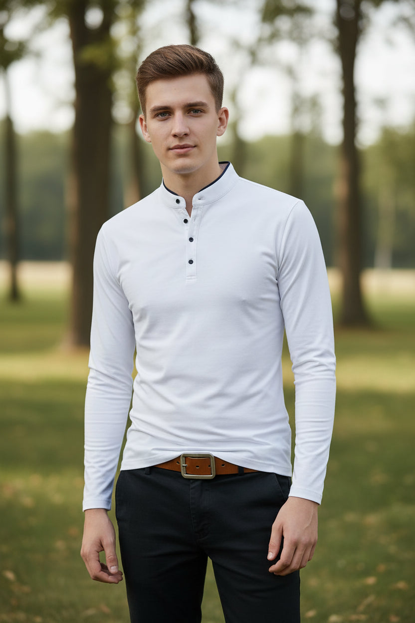 White long-sleeve shirt with black buttons worn by a person on a gray background