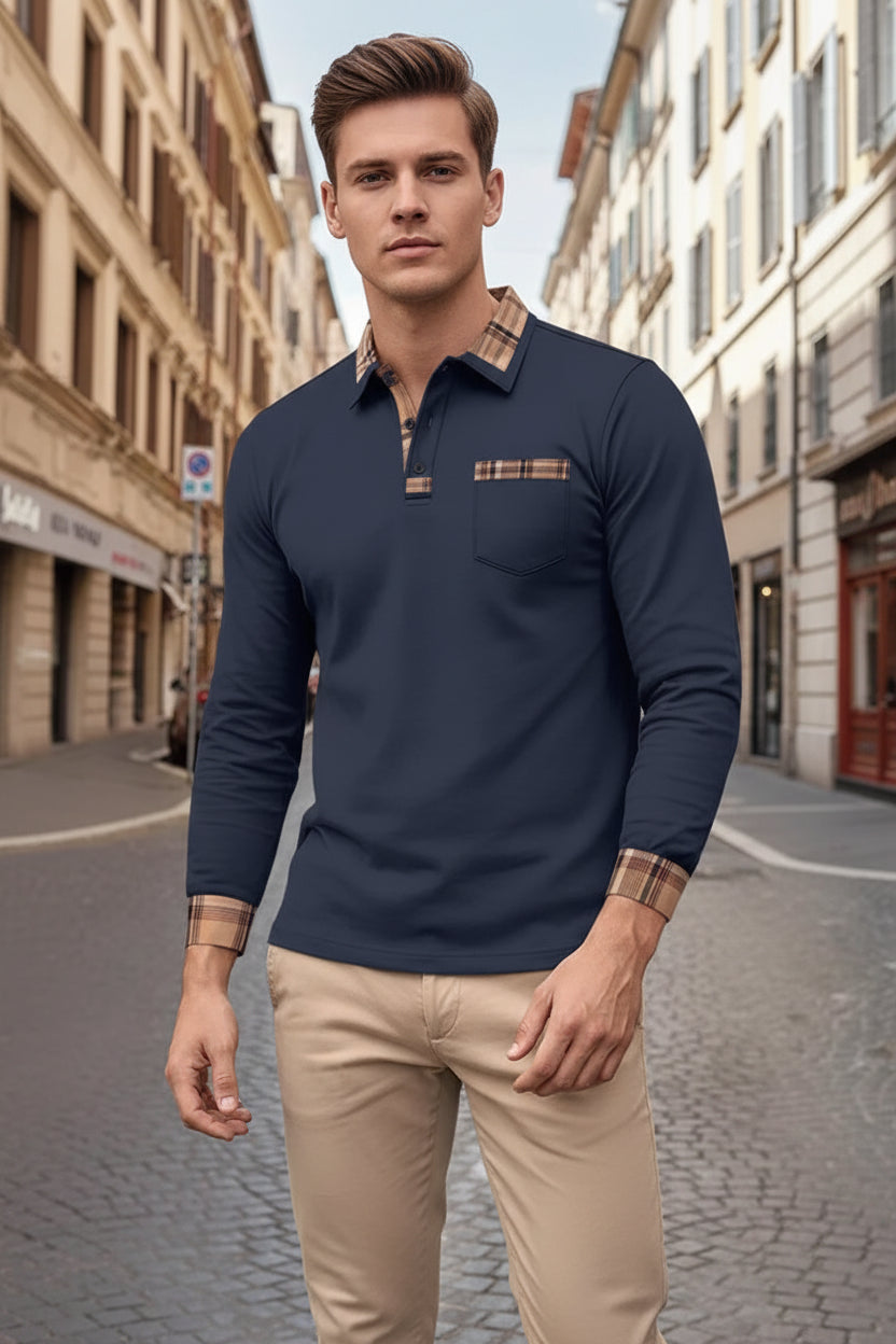 Man wearing a navy long-sleeve polo shirt with plaid accents on a city street.