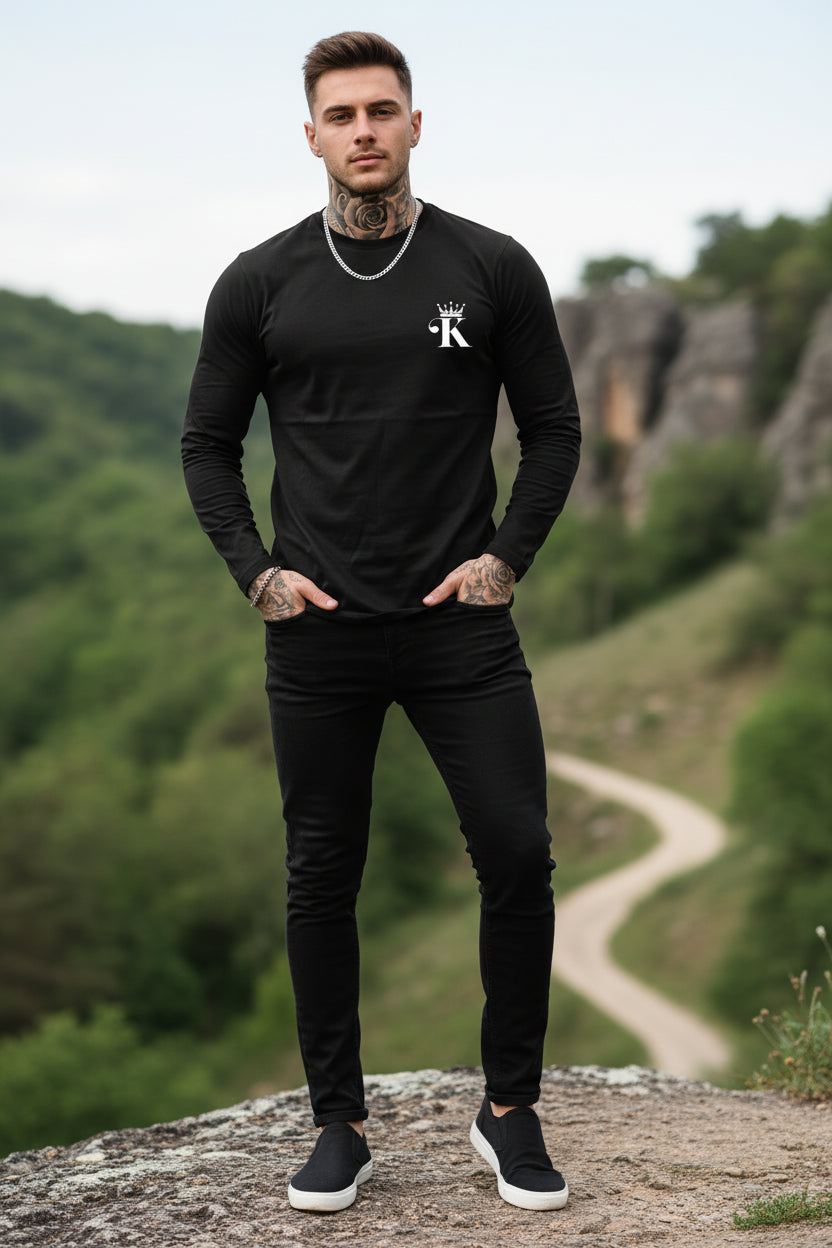 Person wearing a black long-sleeve shirt with a logo on a gray background