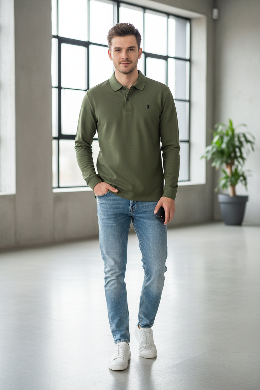Green polo shirt with Ralph Lauren logo being held by a hand on a hanger.