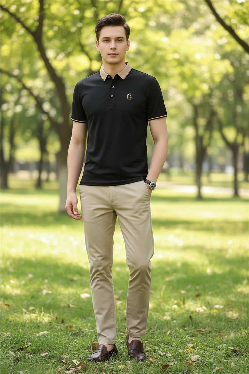 Black polo shirt with a logo on a gray background
