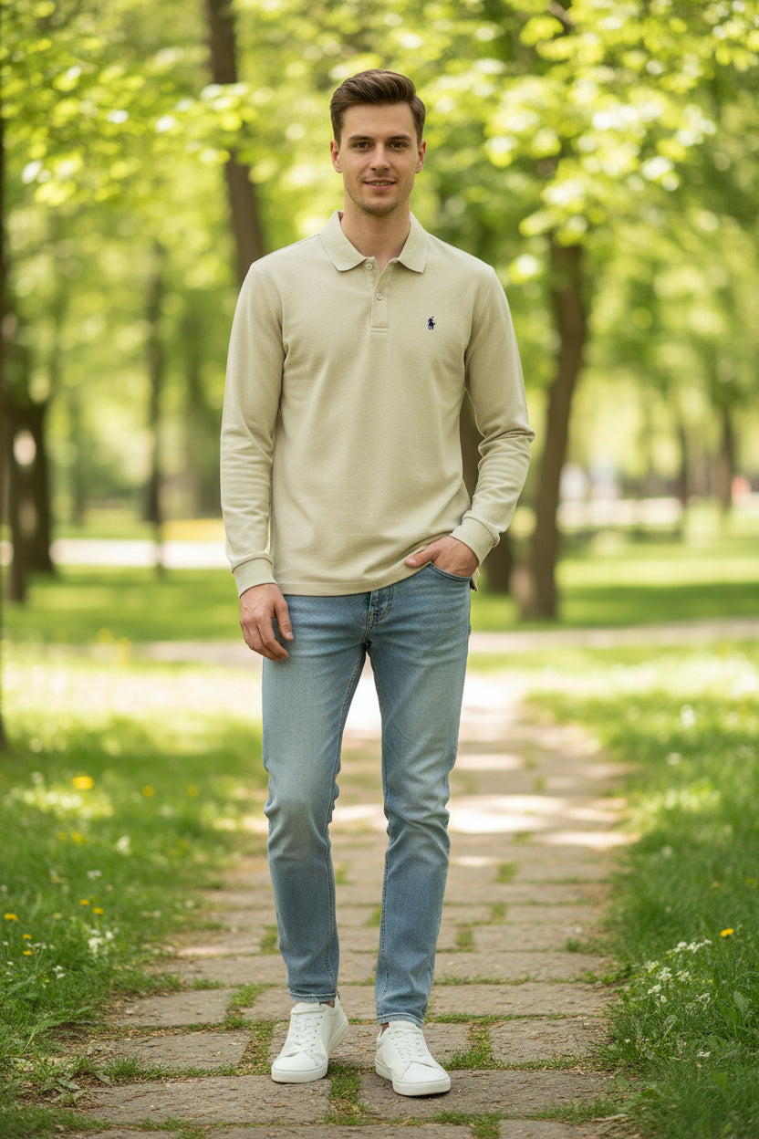 Beige long-sleeve polo shirt with a brand logo on a hanger against a rack of other shirts.