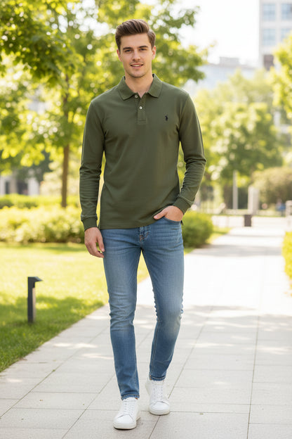 Green polo shirt held by a hand with other shirts in the background