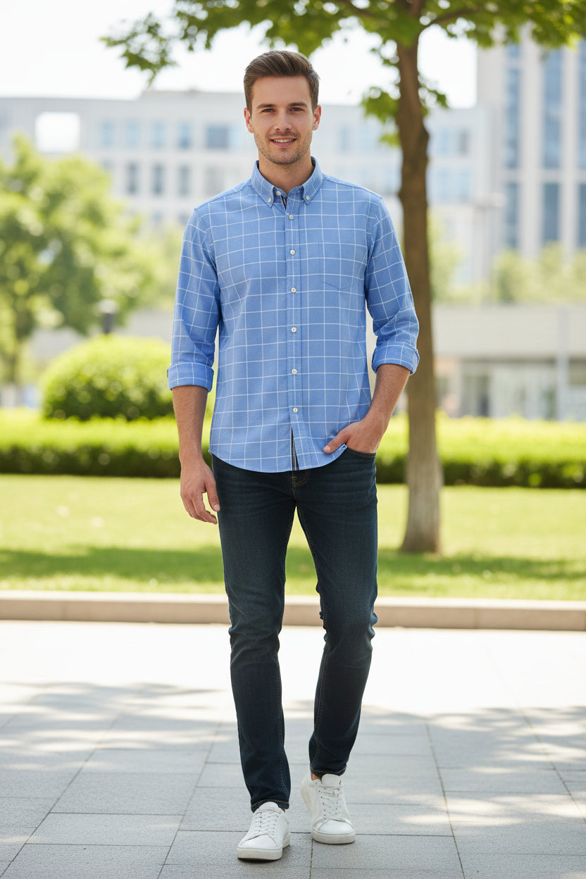 Folded blue checkered shirt with brand logo on a light gray background