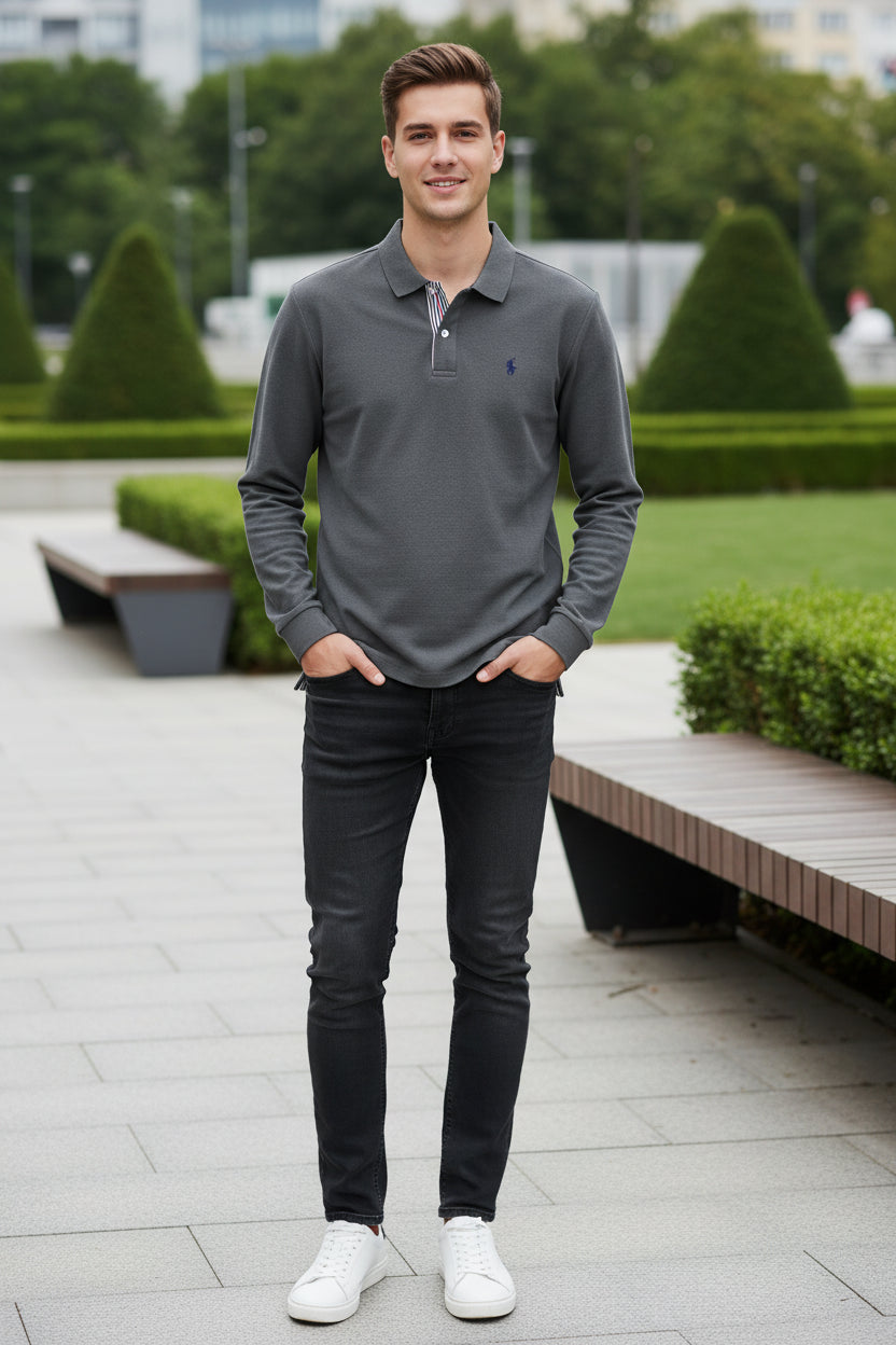 Gray polo shirt on a hanger with a brand logo in front of other colored shirts.