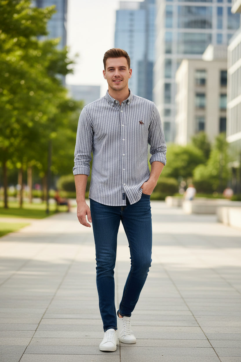 Folded gray and white striped shirt with a small logo on a textured surface