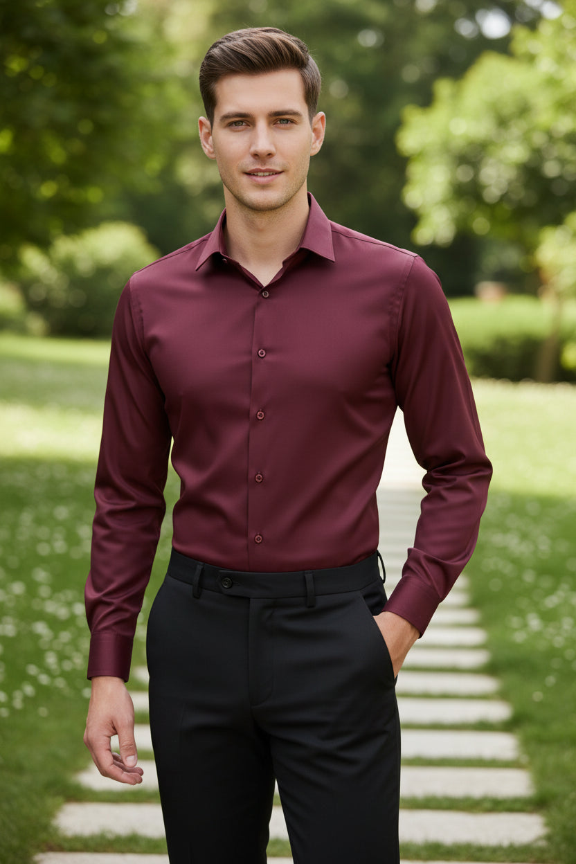 Person wearing a maroon dress shirt and black pants in an indoor setting.