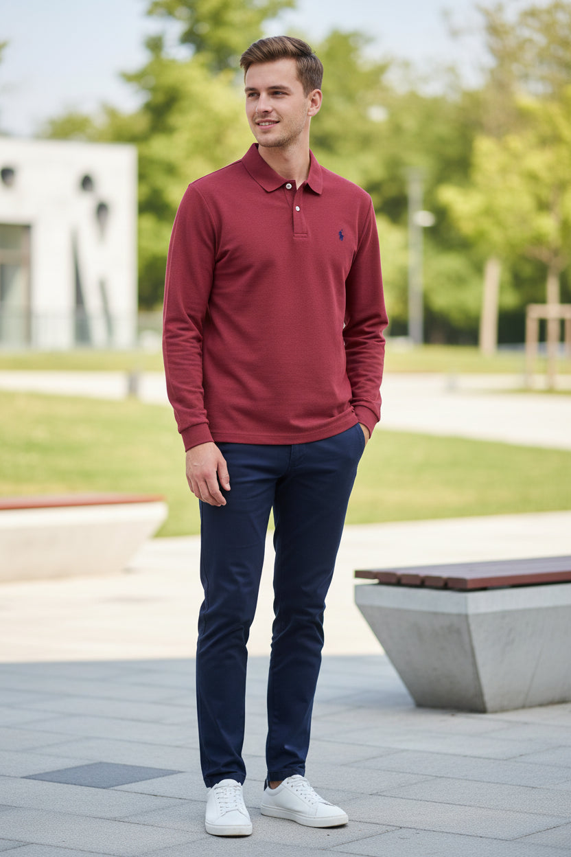Red polo shirt with a brand logo on a hanger, held by a hand.