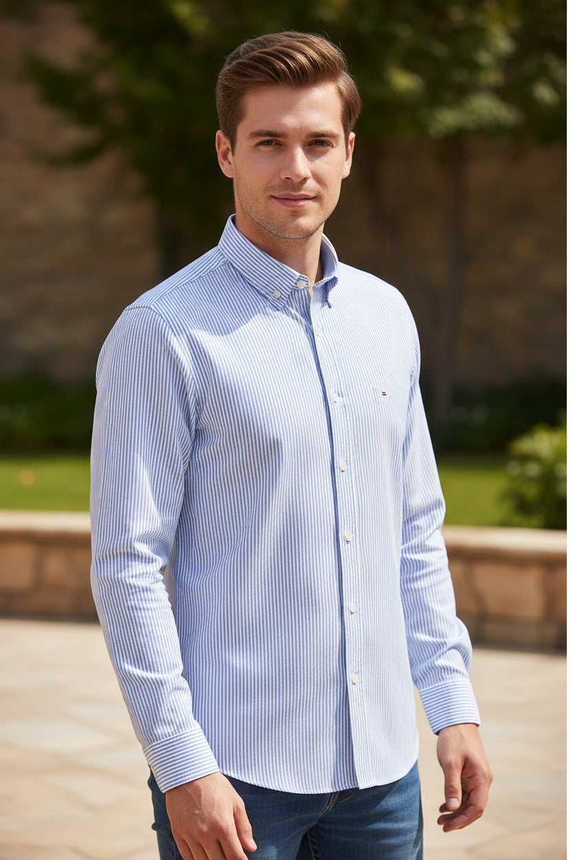 Folded blue and white striped shirt with brand label on a white background