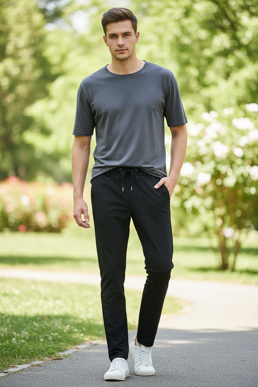 Black pants with drawstring waist on a white background