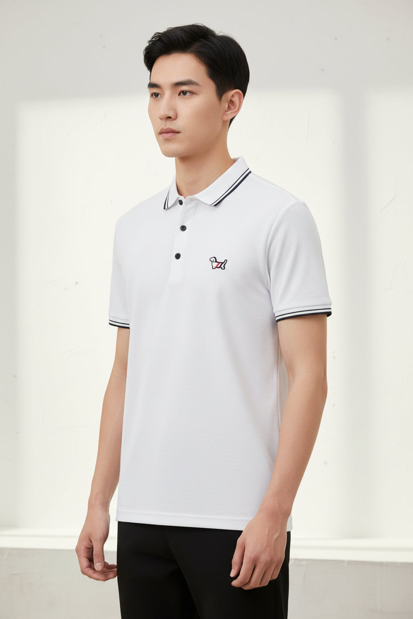 White polo shirt with a logo on a hanger in a clothing store.
