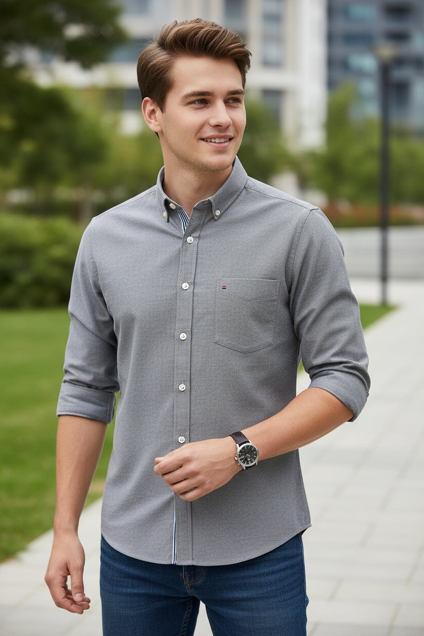 Folded gray shirt with a blue collar on a light gray background