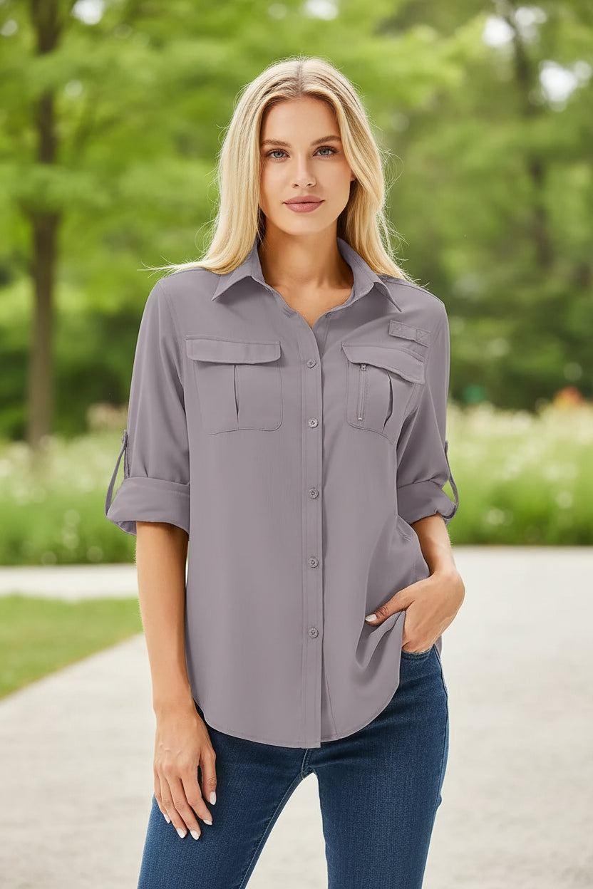 Woman wearing a gray button-up shirt with rolled-up sleeves on a white background