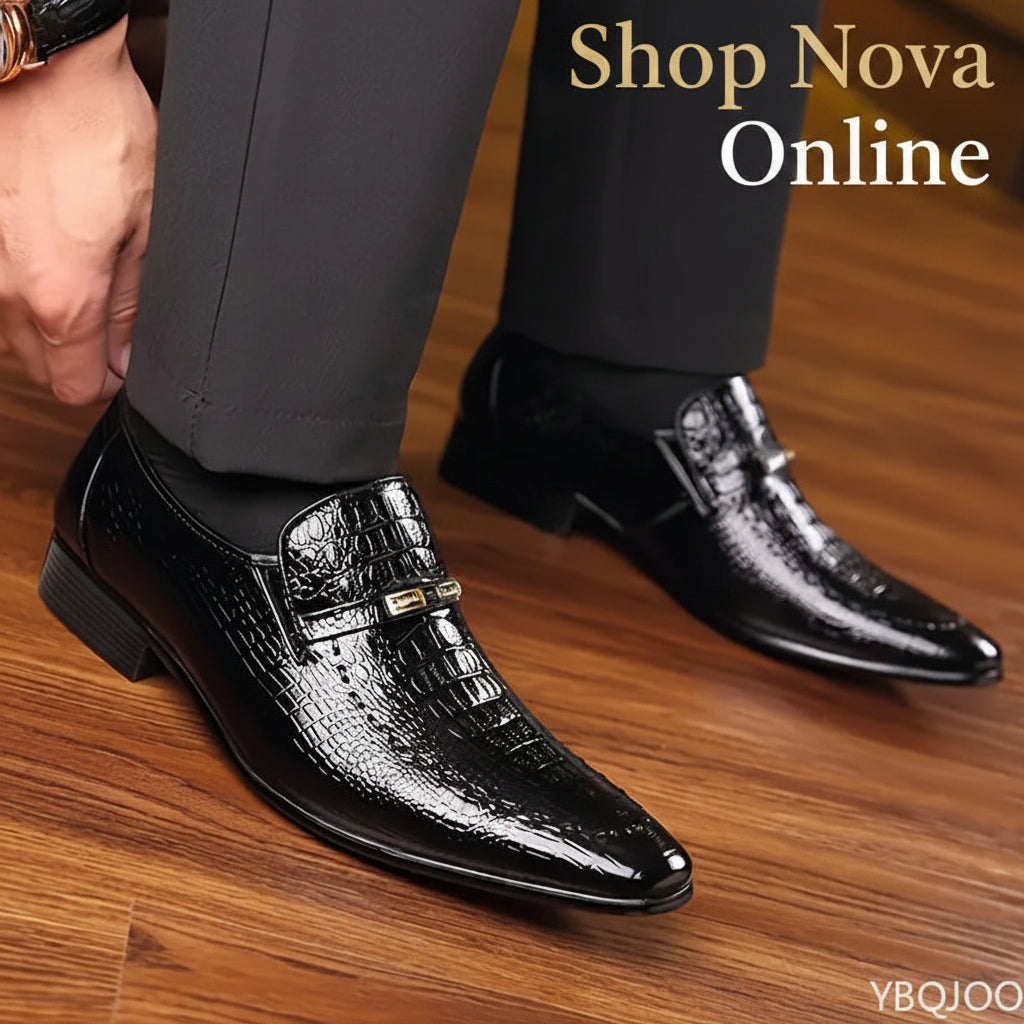 Black dress shoes with crocodile texture on a wooden floor