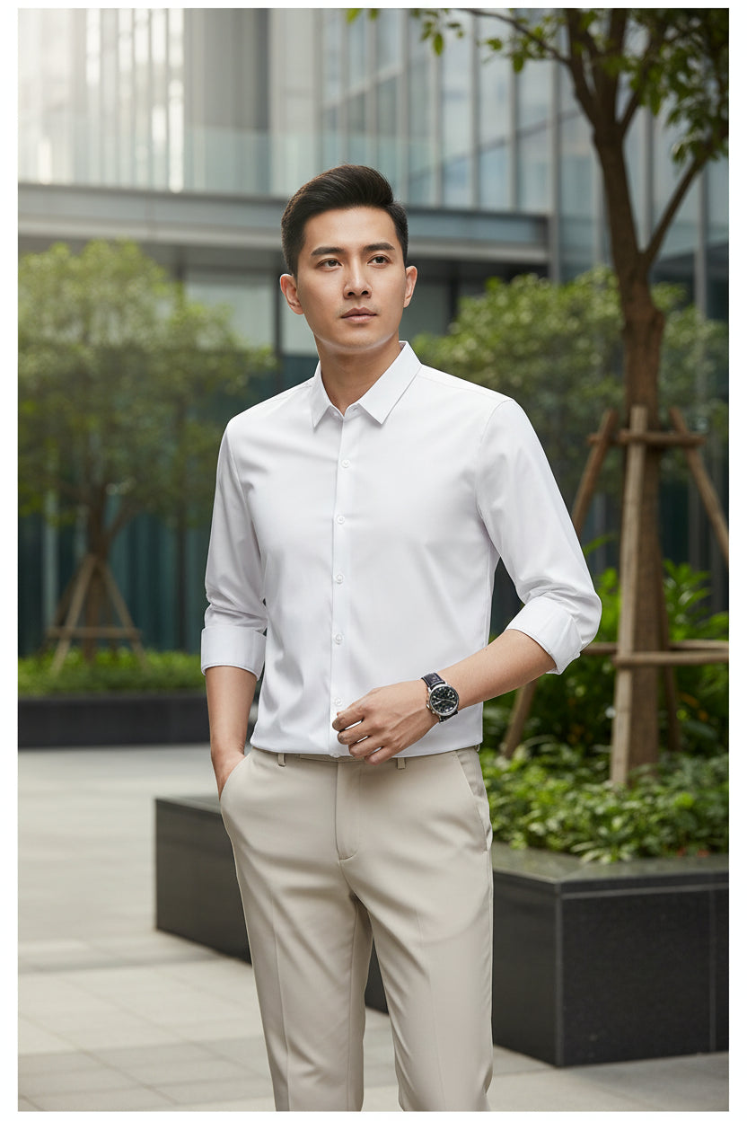 Person wearing a white dress shirt with rolled-up sleeves and beige pants on a black background