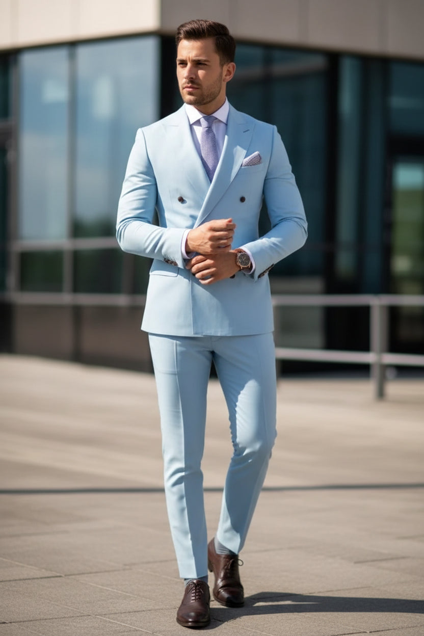 Light blue suit with a patterned tie and pocket square, worn by a person.
