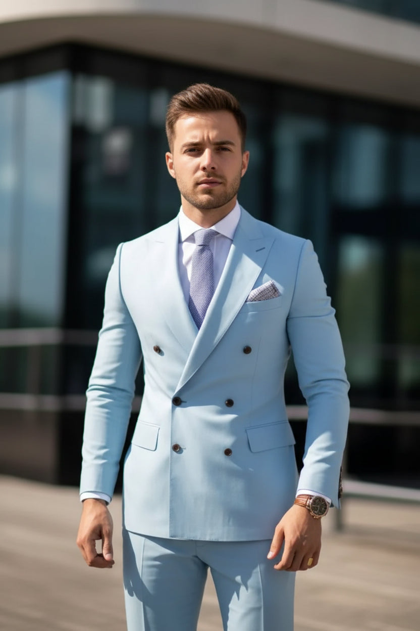 Light blue suit with a patterned tie and pocket square, worn by a person.