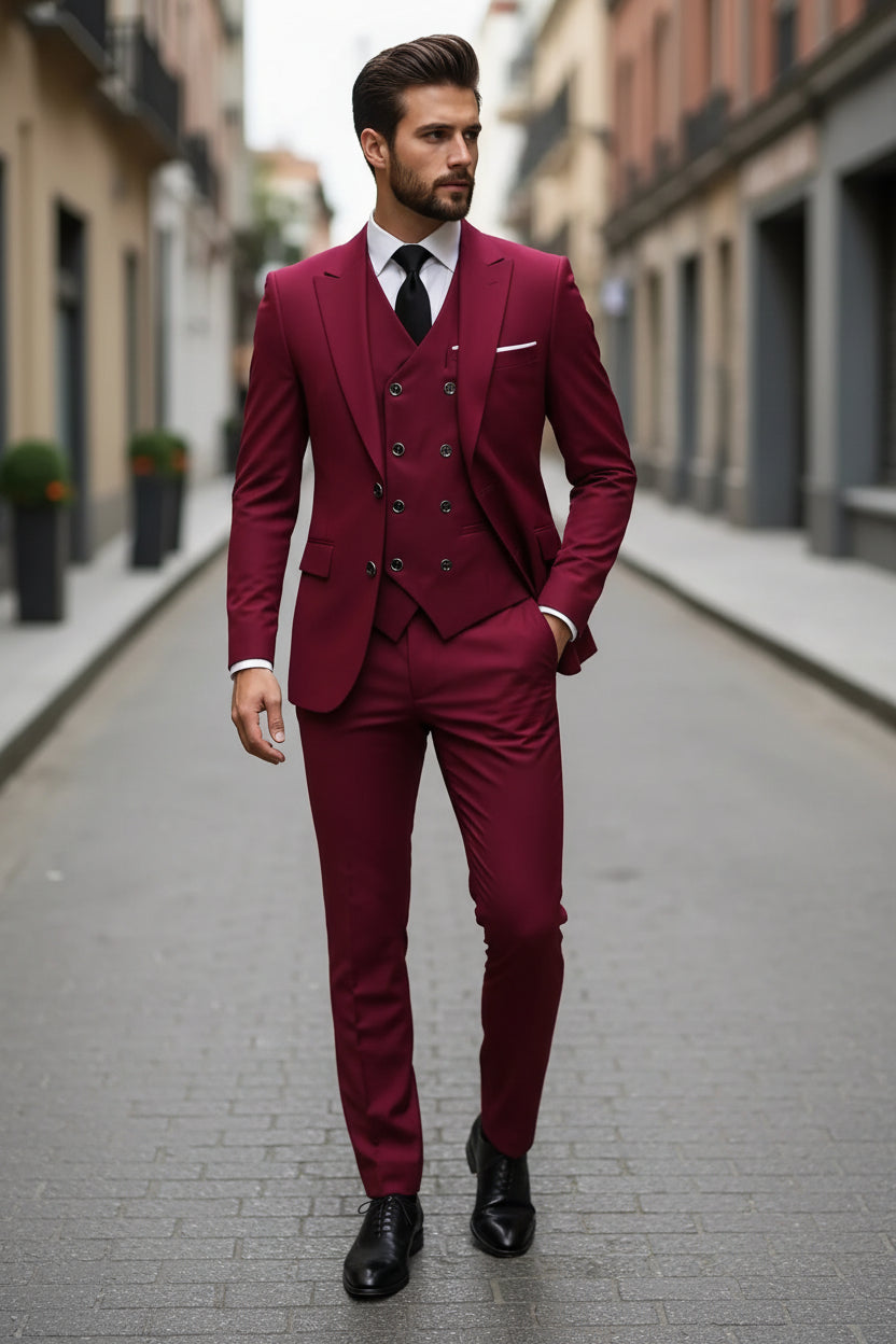 Man wearing a burgundy suit with a black tie on a city street.