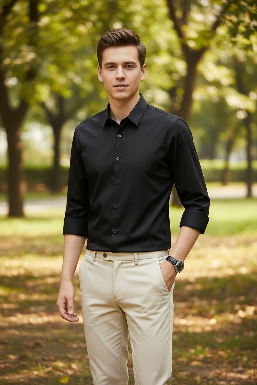 Black dress shirt worn by a person on a dark background