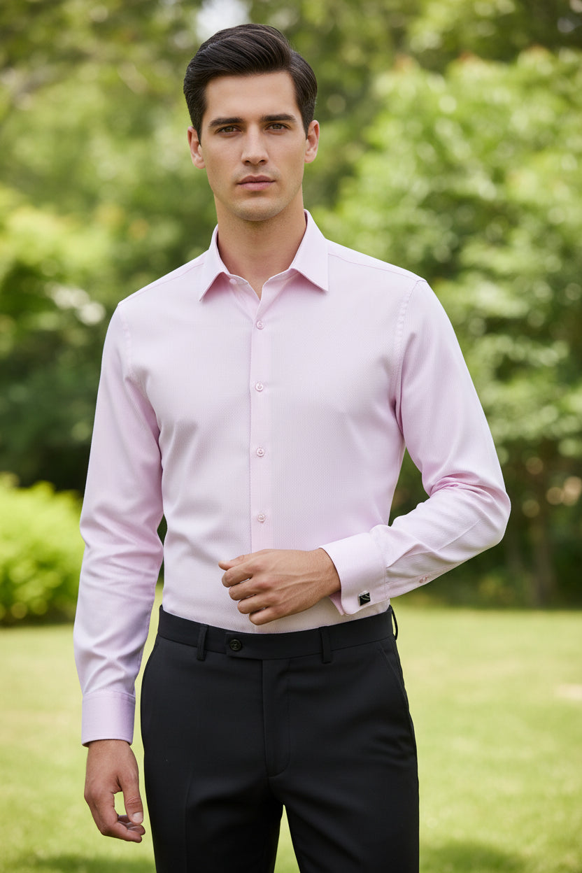 Folded pink dress shirt with cufflinks on a light gray background
