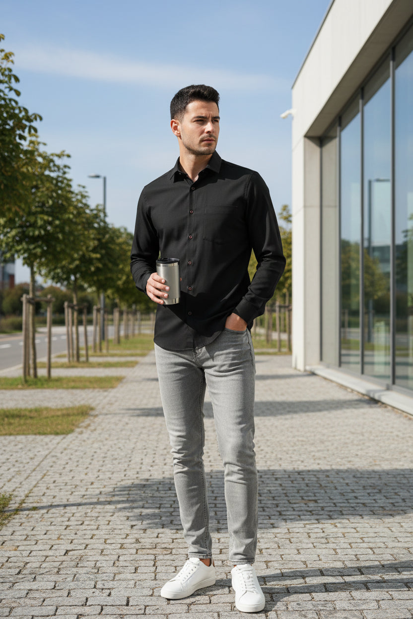 Black shirt on a hanger against a white background