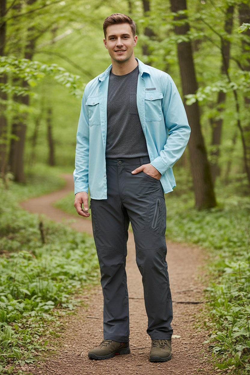 Person wearing dark gray pants with zippers on a white background