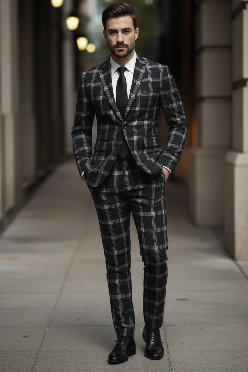 Man wearing a black and gray checkered suit with a blurred background