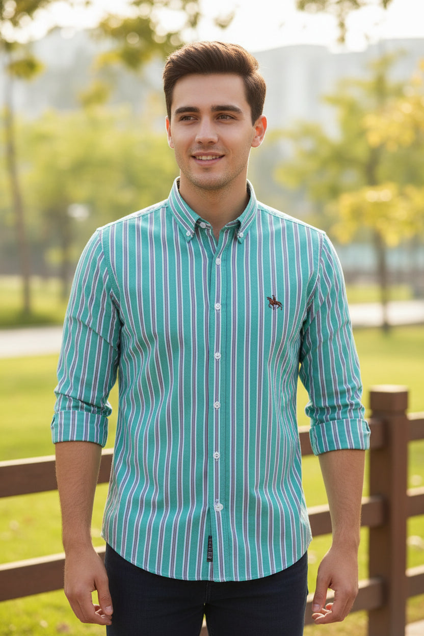 Folded green and purple striped shirt with a logo on a white background