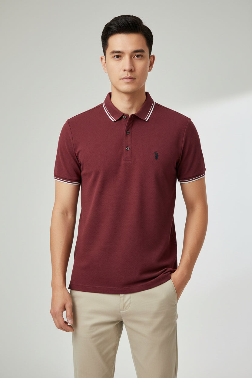 Maroon polo shirt with white trim on a rack of clothes