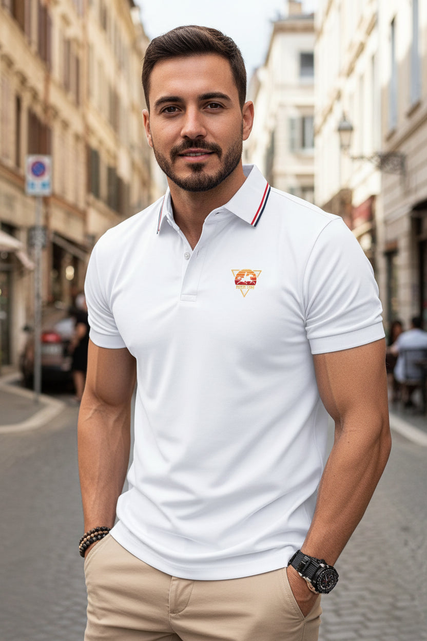 Man wearing a white polo shirt with a logo on a city street