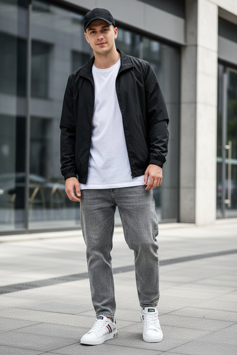White sneakers with black and red accents on a gray textured surface