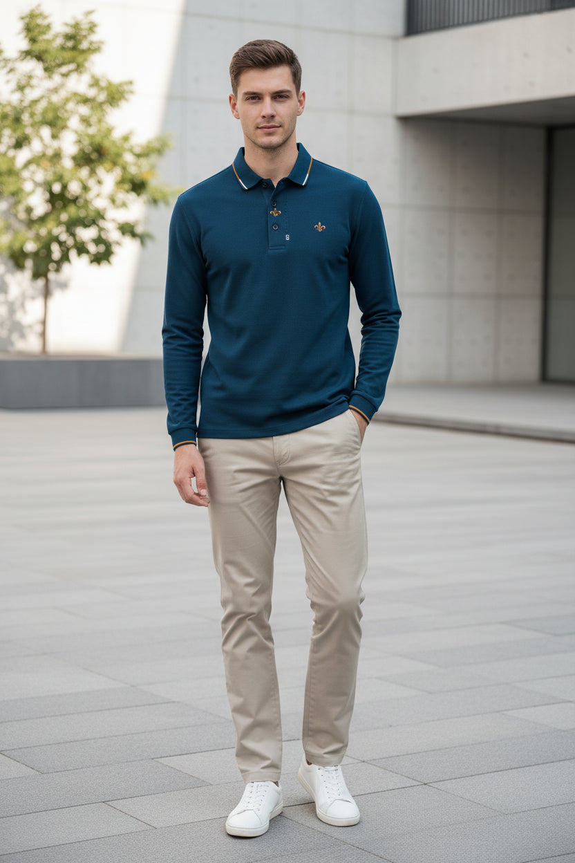 Blue polo shirt with a brand logo held by a hand, with hangers in the background.