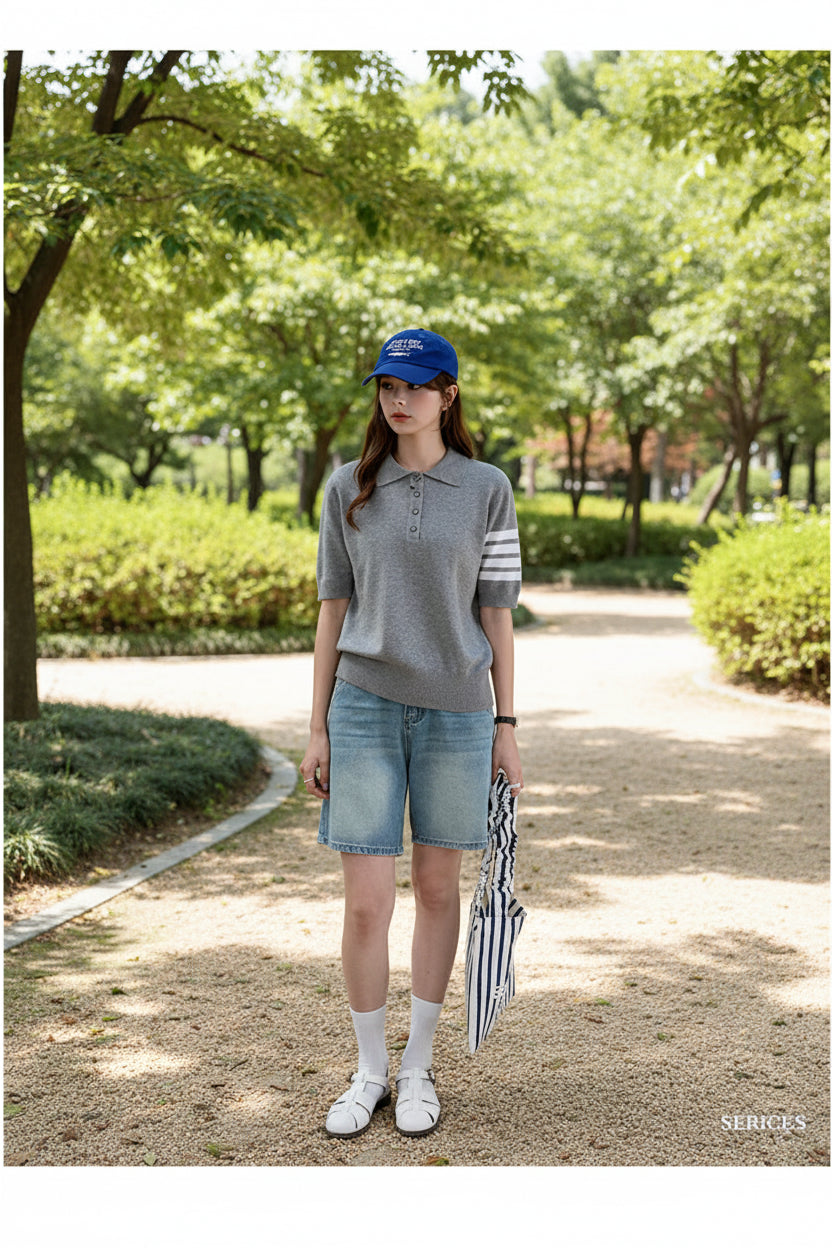 Person wearing a gray polo shirt, blue shorts, and a blue cap in a room with a Celine garment.