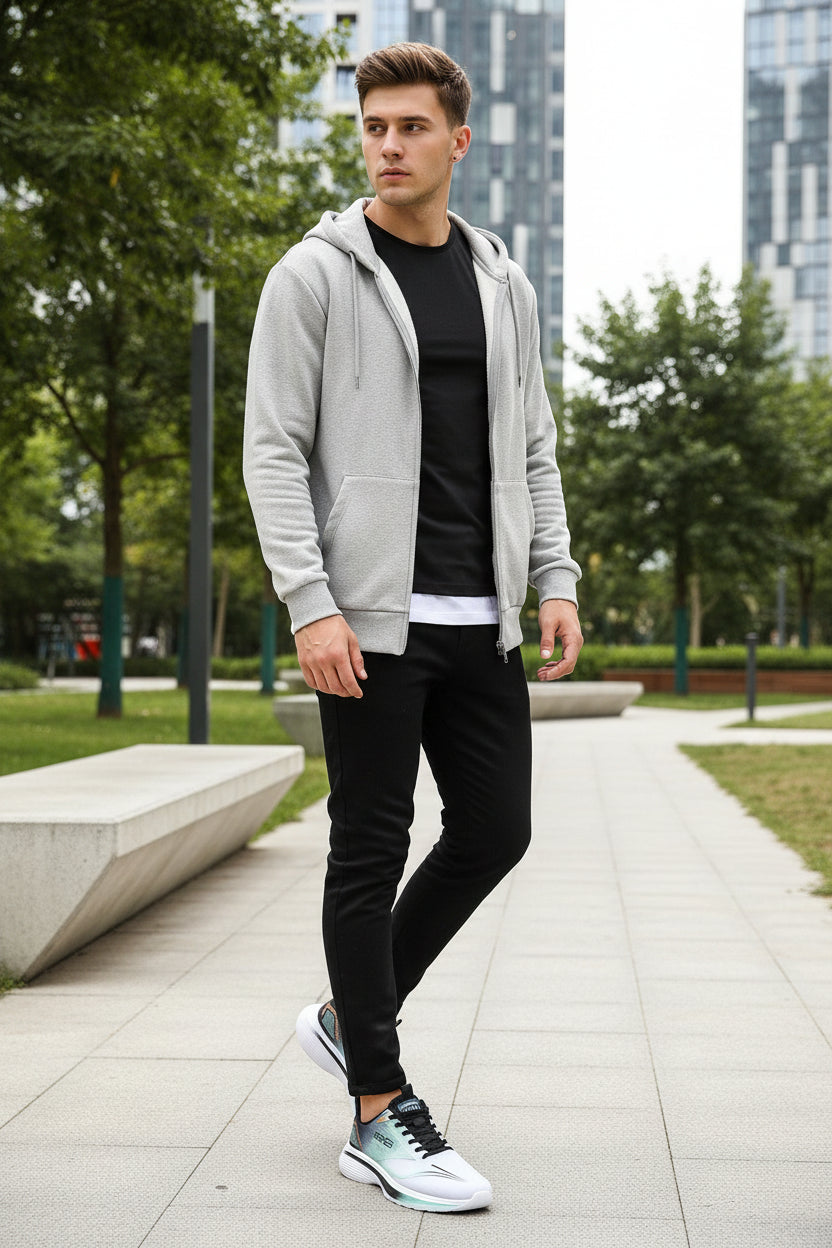 White athletic shoe with black accents held in a hand against a dark background