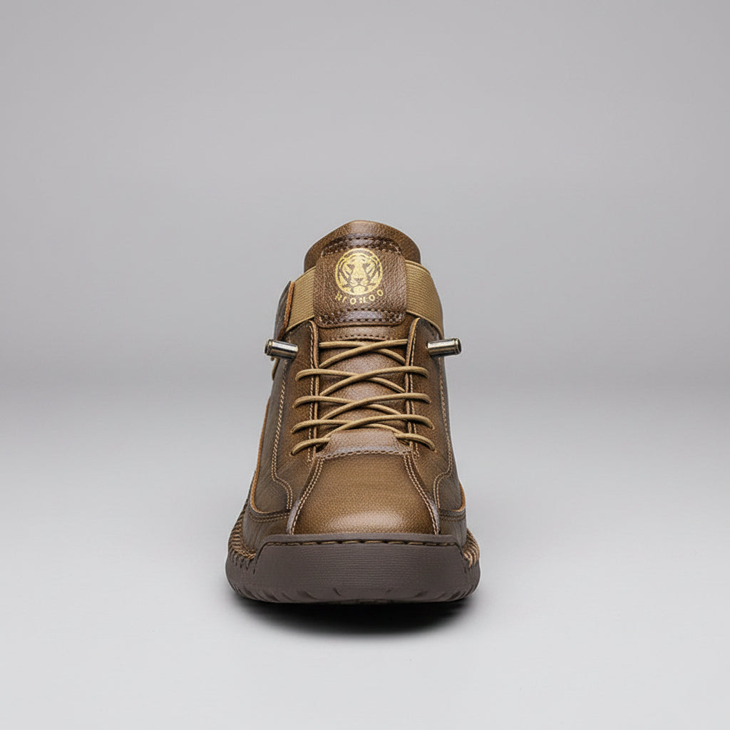 Brown leather boot with visible stitching on a wooden surface