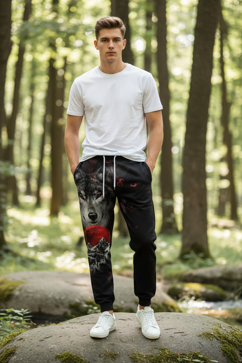 Black sweatpants with wolf and moon design on a white background