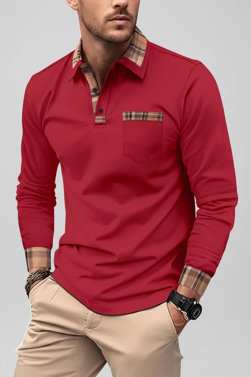 Man wearing a red long-sleeve shirt with plaid accents on a city street.