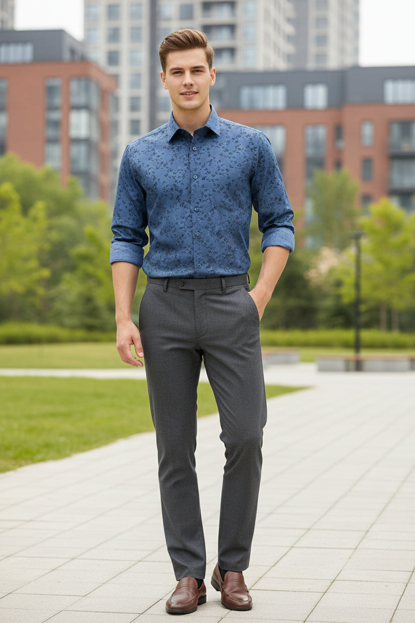 Folded blue shirt with black floral pattern on a white background